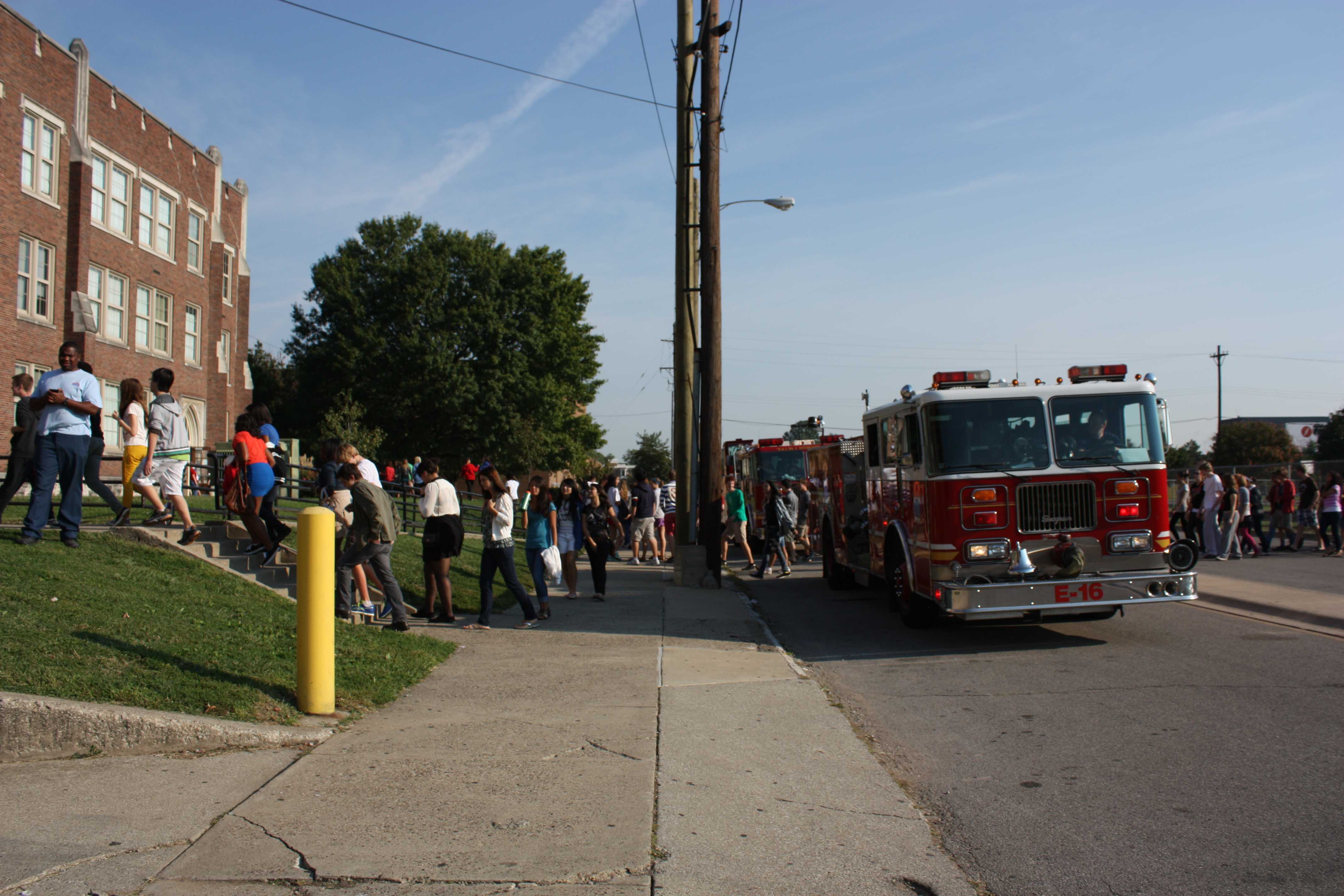 Students proceed back toward school, passing one of the two fire trucks. Photo by Molly Loehr