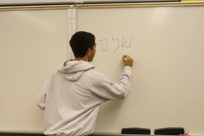 Shpilberg writes in Hebrew on the board. Photo By: Alexis Weaver