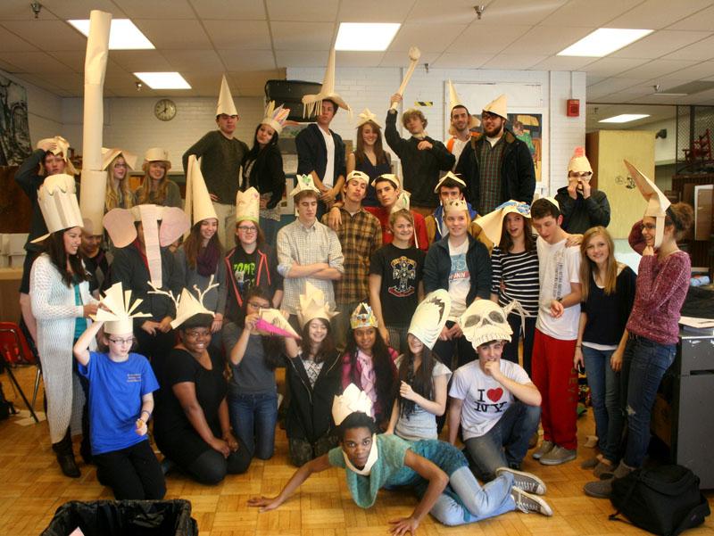 Struggling to simultaneously pose for a group photo on Mr. Deweese’s behalf, Art Club members each do their own poses reflective of the hats they just made