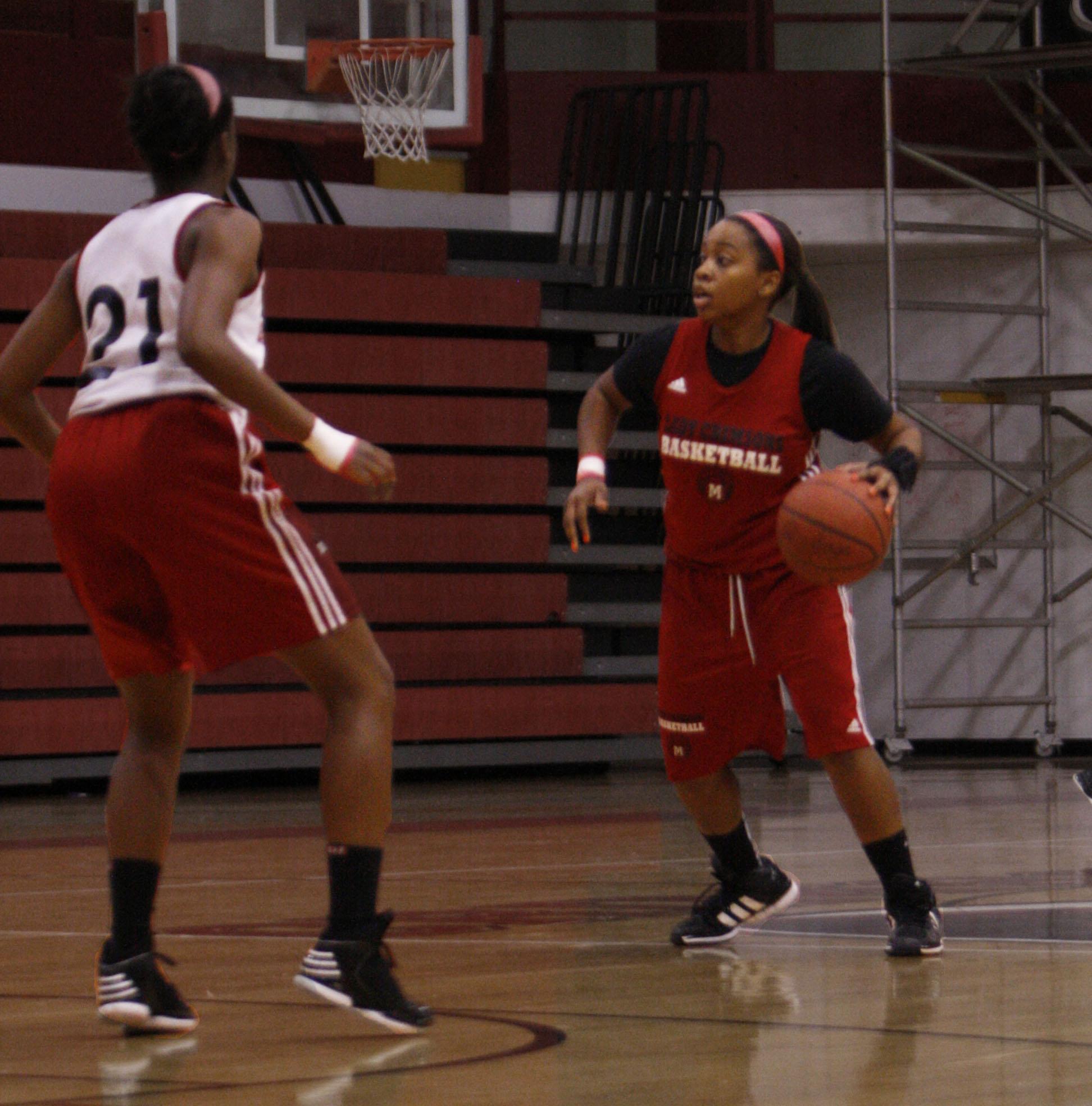 Sophomore, Teanna Curry, dribbles the ball while being guarded by Mackinley Poole.
