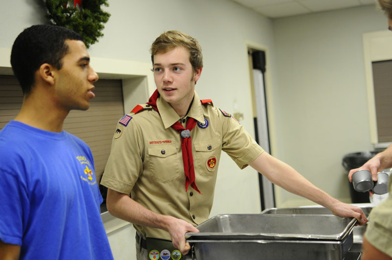 Curtis Lipsey(11) and Bryan Croft(11) of Atherton high school set up serving tables early in the evening. Photo by Jack Steele Mattingly