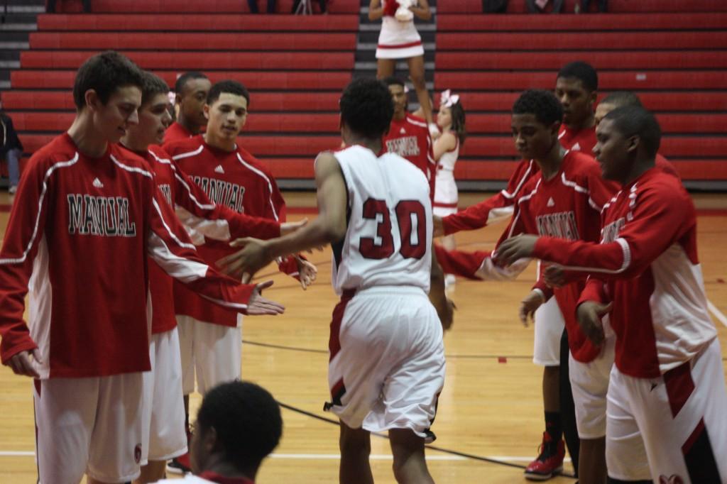 Dwayne Sutton (10, #30) joins his teammates in the starting lineup just before the start of the game.