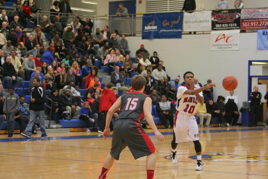 JaKory Freeman (12, #10) makes a quick pass to a teammate to his left. 