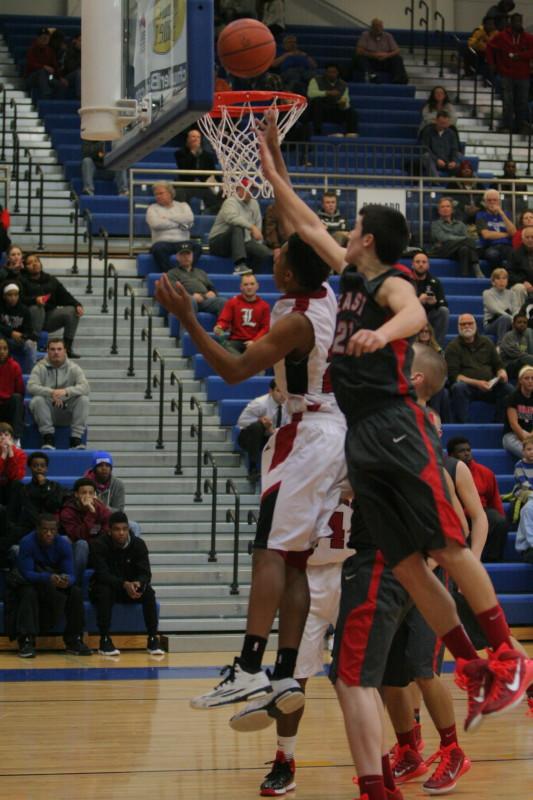 Dwayne Sutton (12, #22) pushes past Tyler Bacon of Bullet East to make a shot.