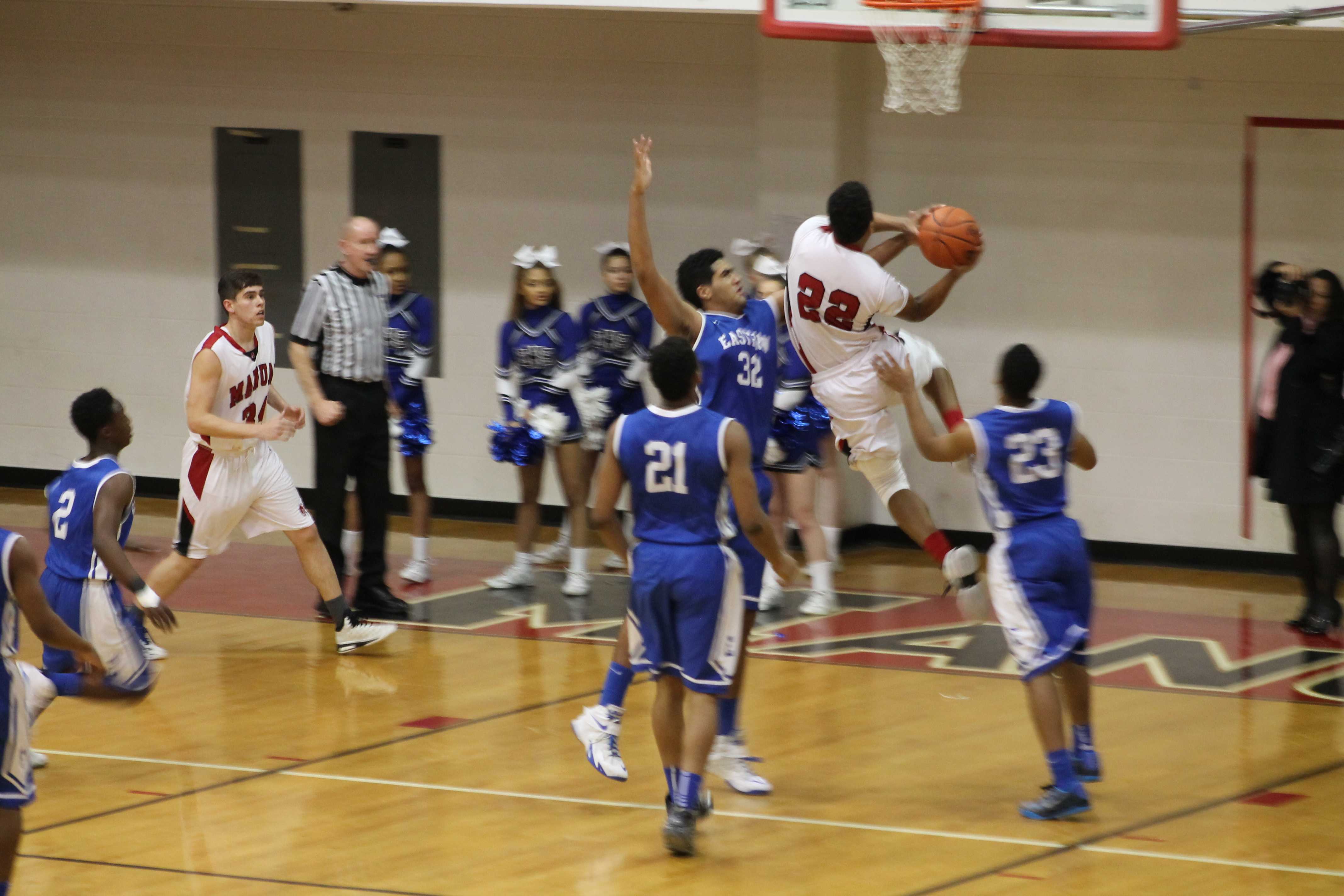 Dwayne Sutton (12, #22) goes up for a layup. Sutton is Manuals leading scorer this season.