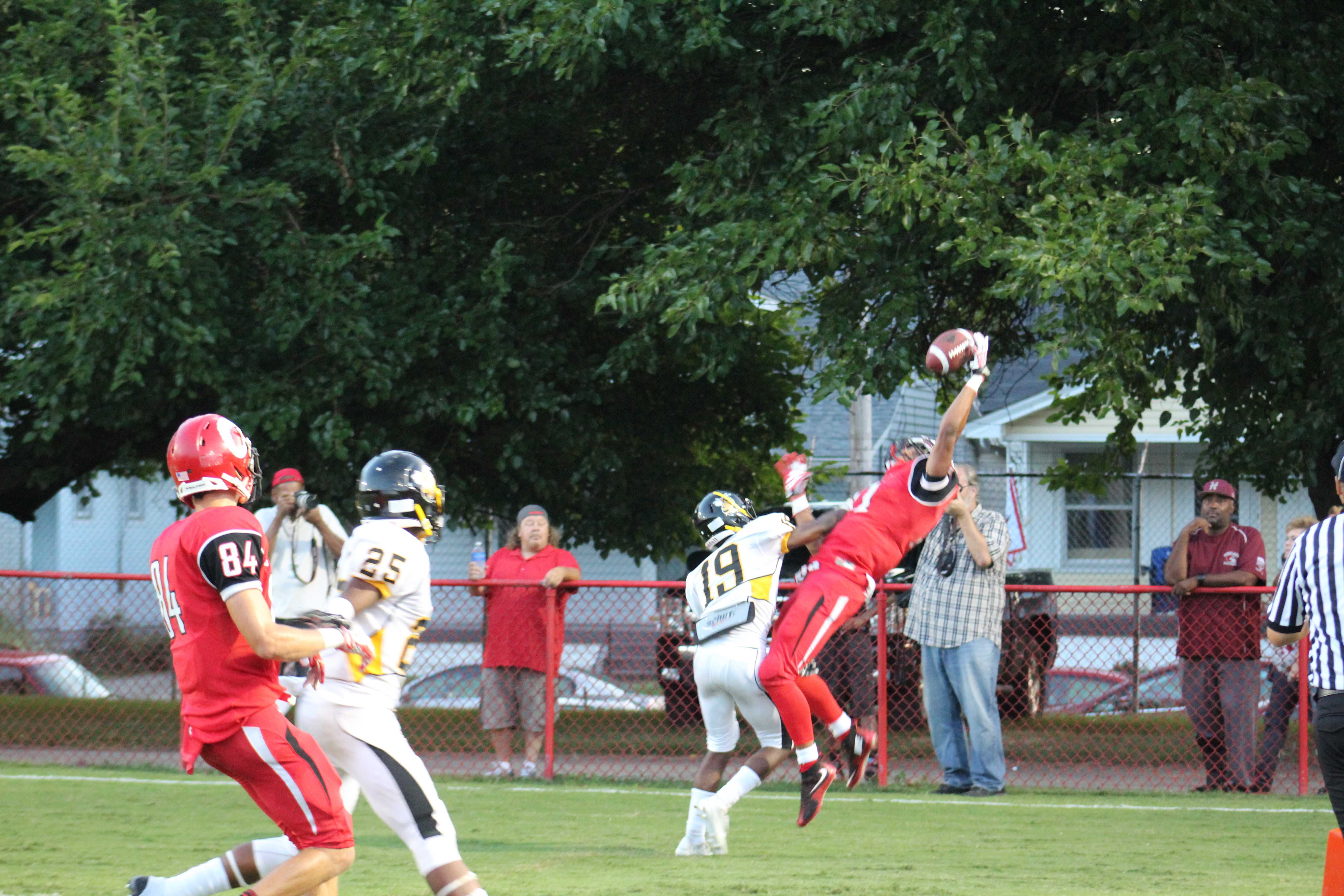 Jailen Carter (11, #11) makes a leaping catch to score Manuals first touchdown of the game. Photo by Kate Hatter 