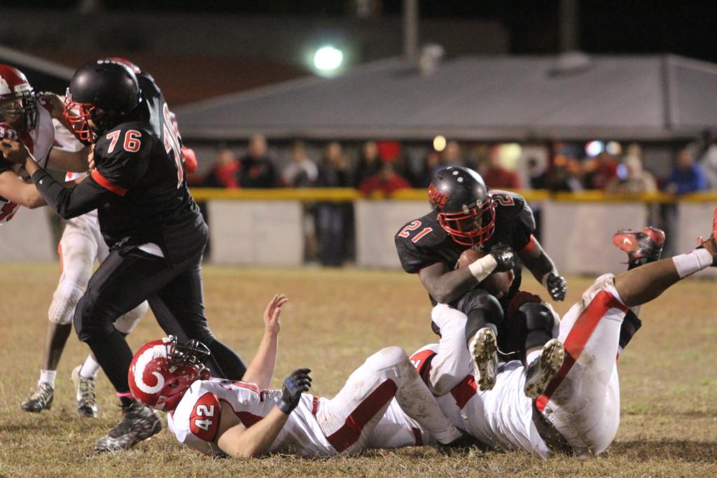 Sean Cleasant (11, #52) and Anthony Kyser (12, #42) take down PRPs Daniel Parker (12, #21). Photo by Kate Hatter