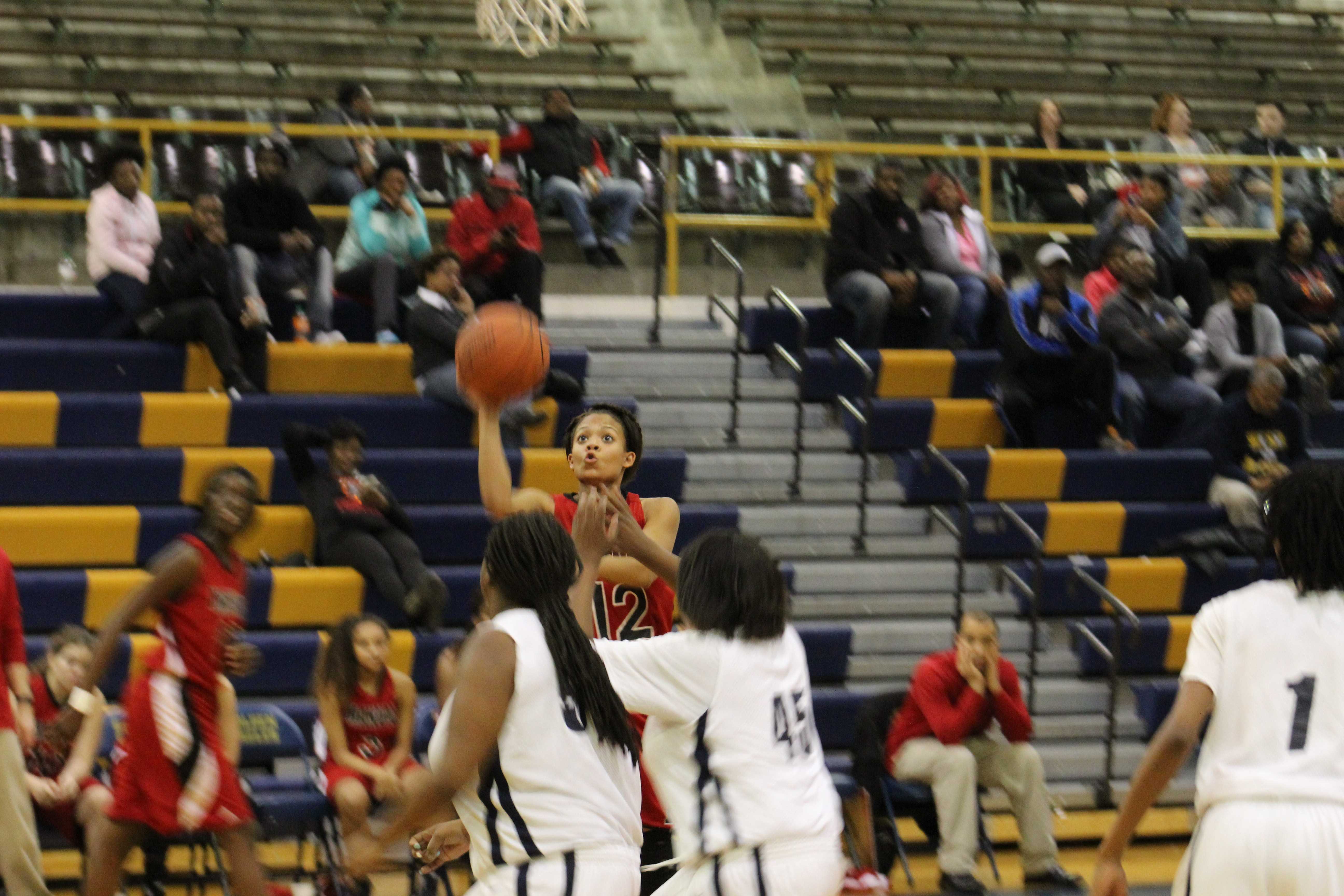Tyonne Howard (12, #12) attempts a lay up. Photo by Kate Hatter