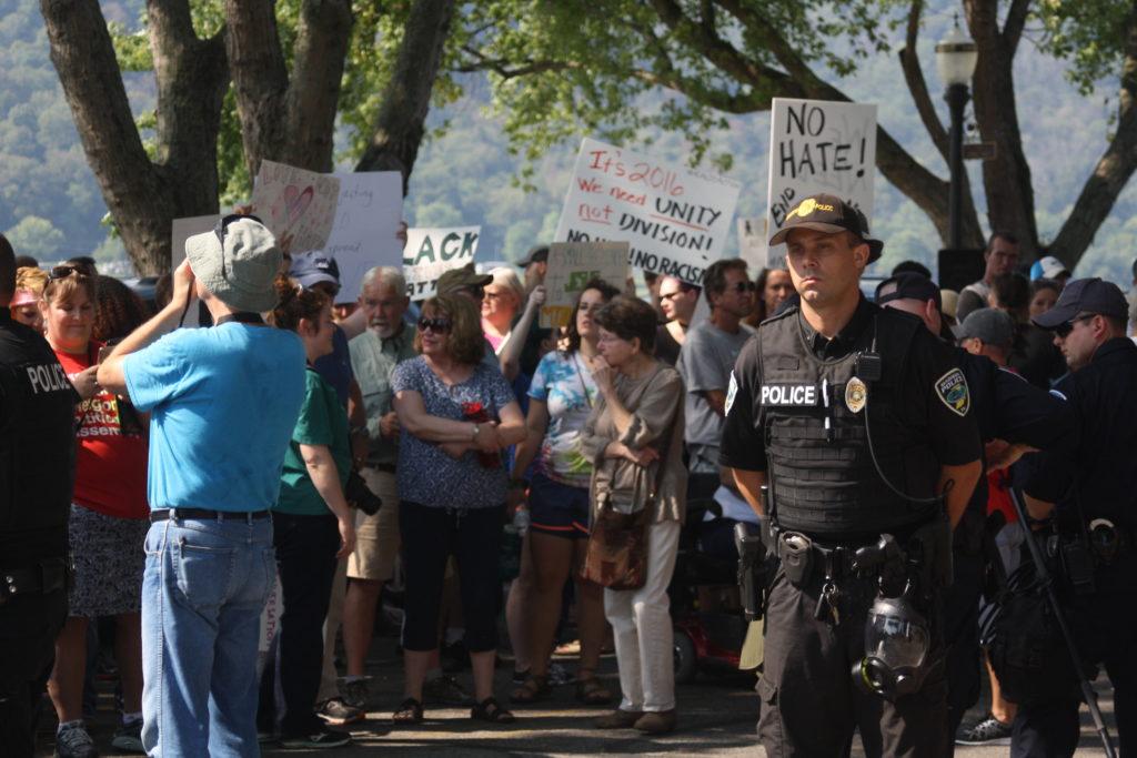 Protesters stand behind police officers. Photo by Phoebe Monsour.