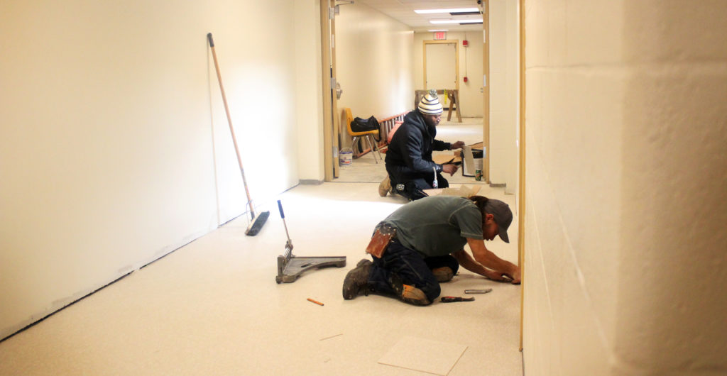 Contractors work to complete the new second floor hallway. Friday, Dec. 2, 2016. This hallway will connect the front of the building, to the back. Photo by Robert Spencer.
