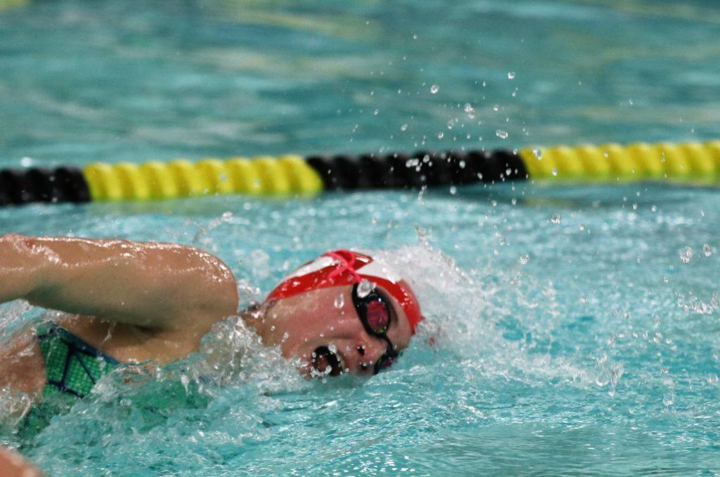 Annie Michael (12, HSU)  swims in a freestyle heat. Photo by Grace Bradley. 