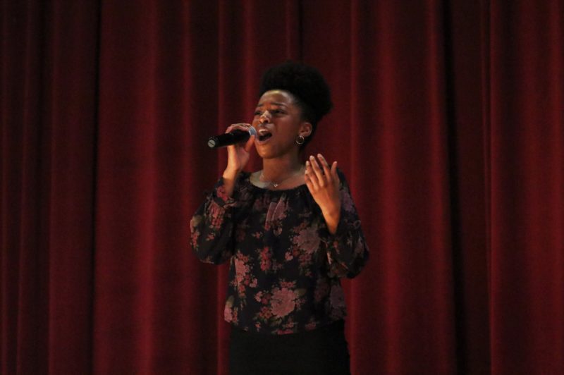 Sydney Finley sings Safe in His Arms during the Black History Month program. Photo by Grace Bradley. 