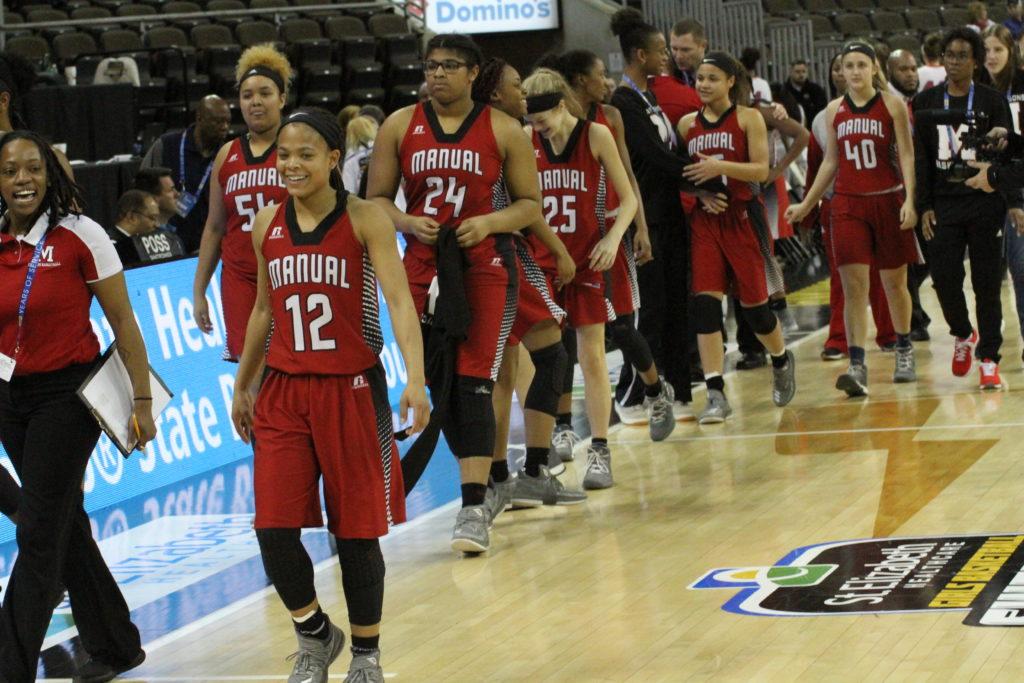 The Crimsons go through the post-game handshake line after defeating Scott County in the KHSAA Sweet 16. Photo by Richard Bowling. 