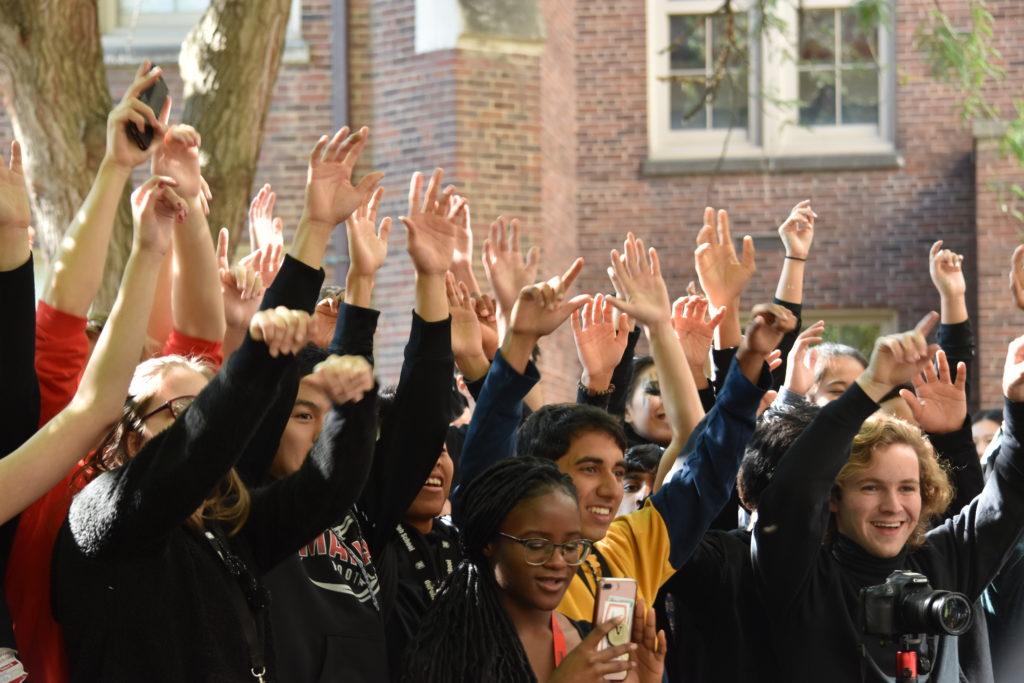 Students at Ramstock wave their arms in sync to the Motley Workout Warriors. Photo by Piper Hansen.