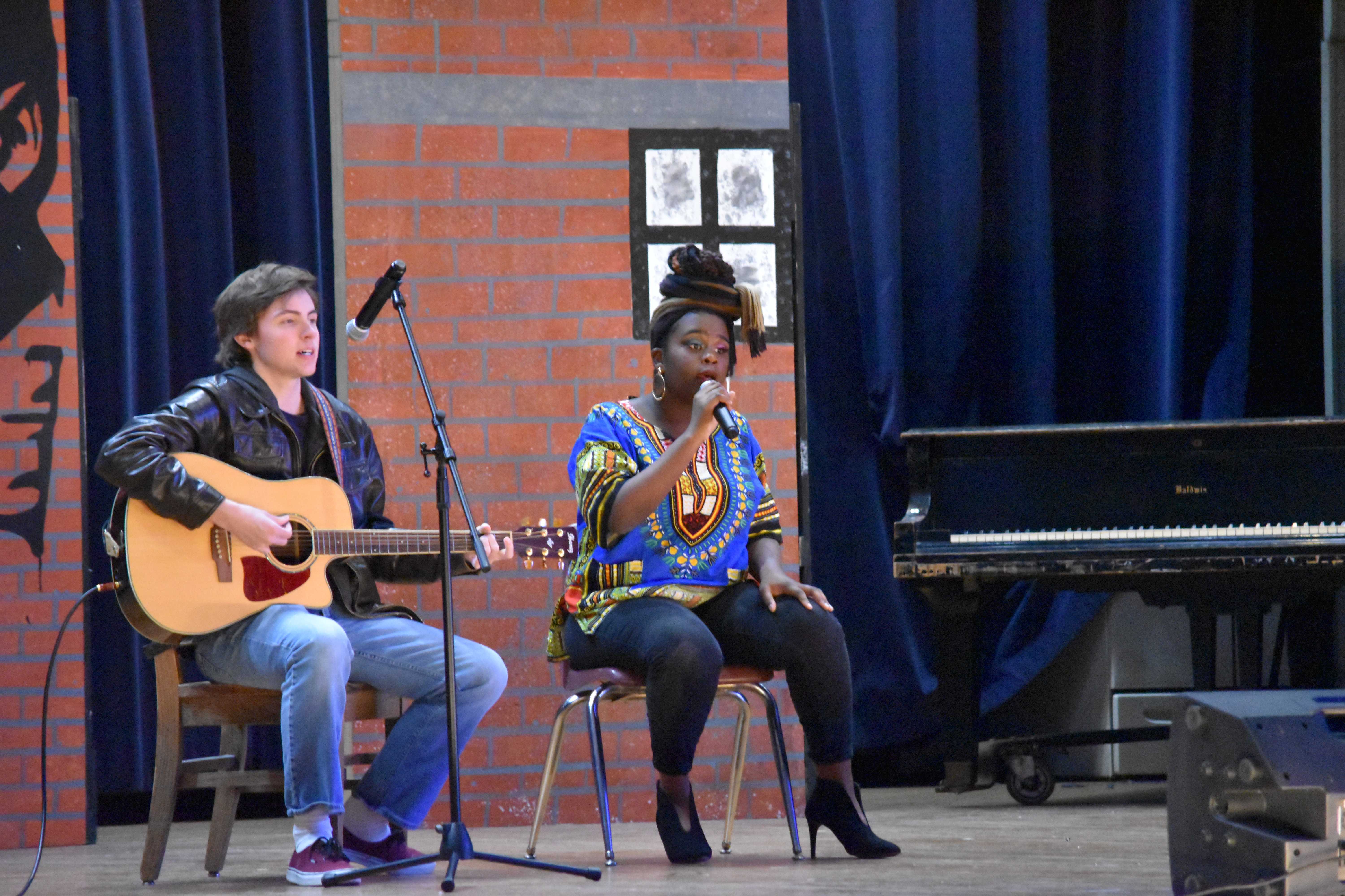 Jonathan Sutphin (11, YPAS) and Jania Gomes (11, YPAS) perform an acoustic rendition of Bob Marleys Redemption Song. This was just one of Gomes many performances in this years program. It’s a song that brings peace, because it’s saying, ‘We’re done with the hatred, we’re gonna overcome this, and we’re just all gonna sing and come together,” Gomes said. Photo by Piper Hansen.