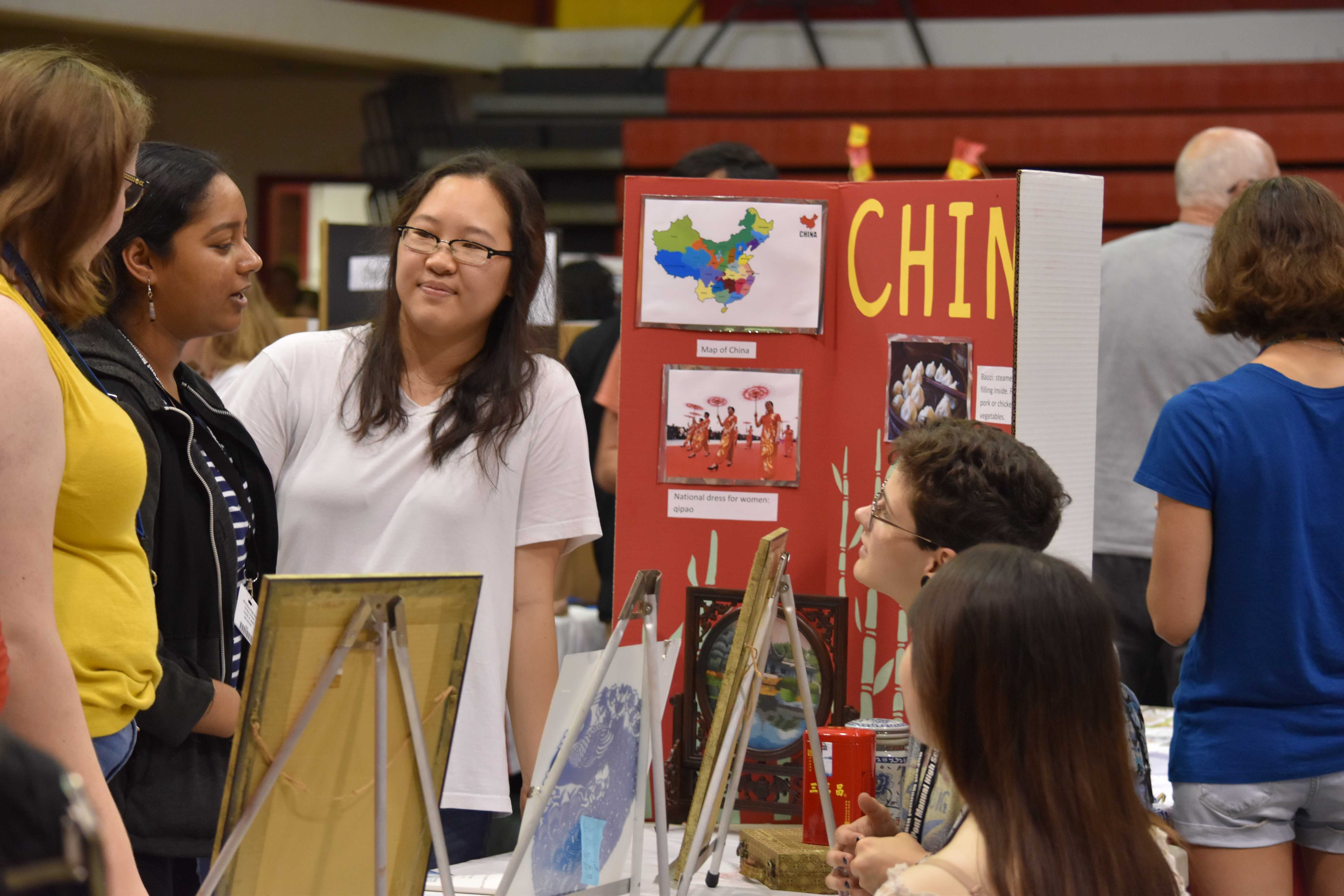 Students gather at the China table to ask questions about current events in the country today. Photo by Piper Hansen.