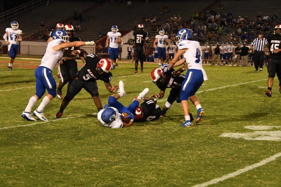Manuals defense puts a stop to the offensive progression of Oldham County. Photo by Pieper Mallett. 