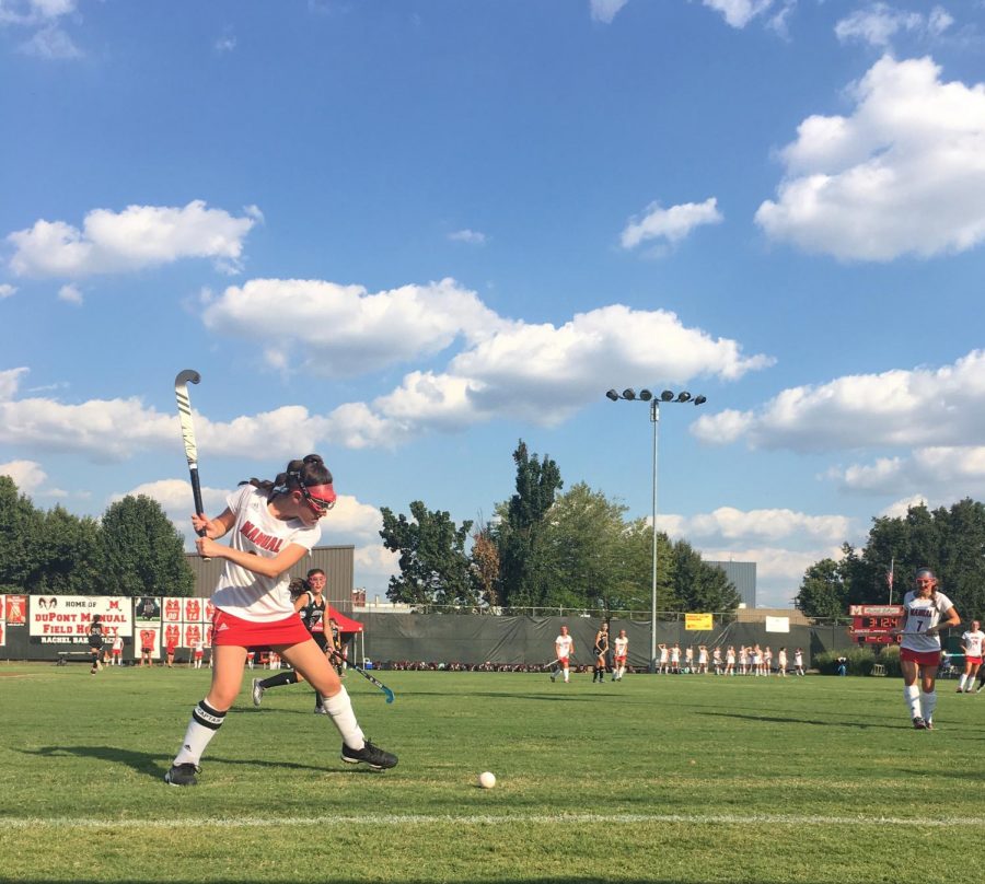 One of the team captains of Manual’s freshman field hockey team, Macy Carmony gears up to hit the ball back into play. Photo by Ella Dye.