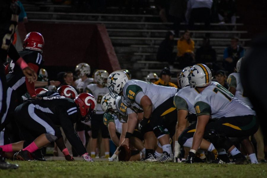 St. X prepares to snap the ball to the quarterback to start the play. Photo by Cesca Campisano.