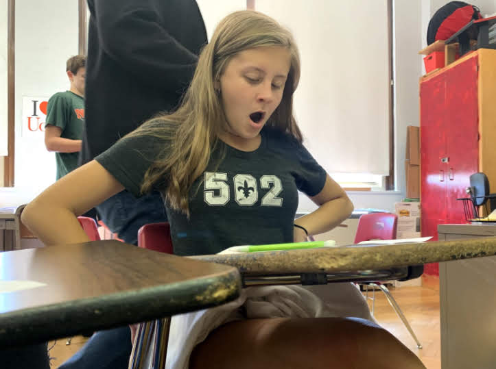 A student yawns during a normal day of classwork early in first block as they prepare to pack-up before heading to second block.