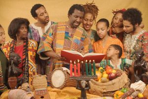 A family celebrates Kwanzaa by reading the scripture together. 