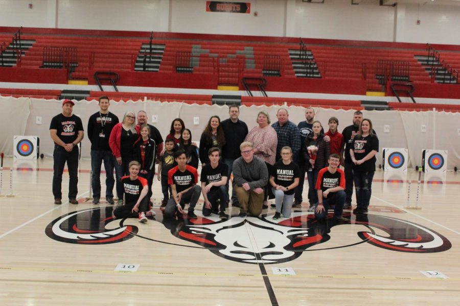 The+six+seniors+from+the+archery+team+and+their+families+and+coaches+lined+up+for+senior+night.+Photo+by+Anna+Schroll.