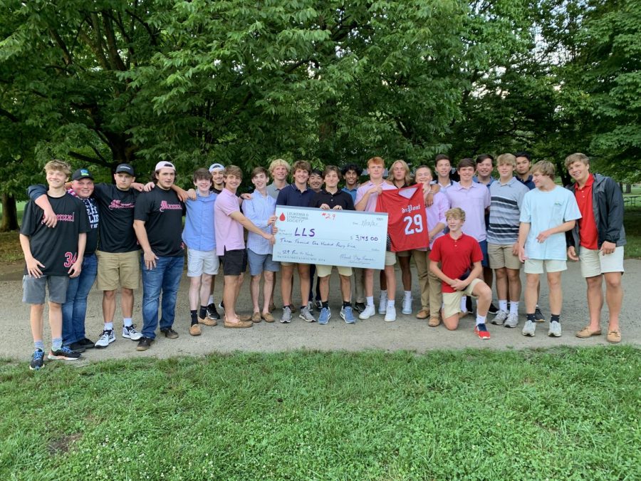 Photo of the 2022 lacrosse team with the $3,145 check made out to LLS. 