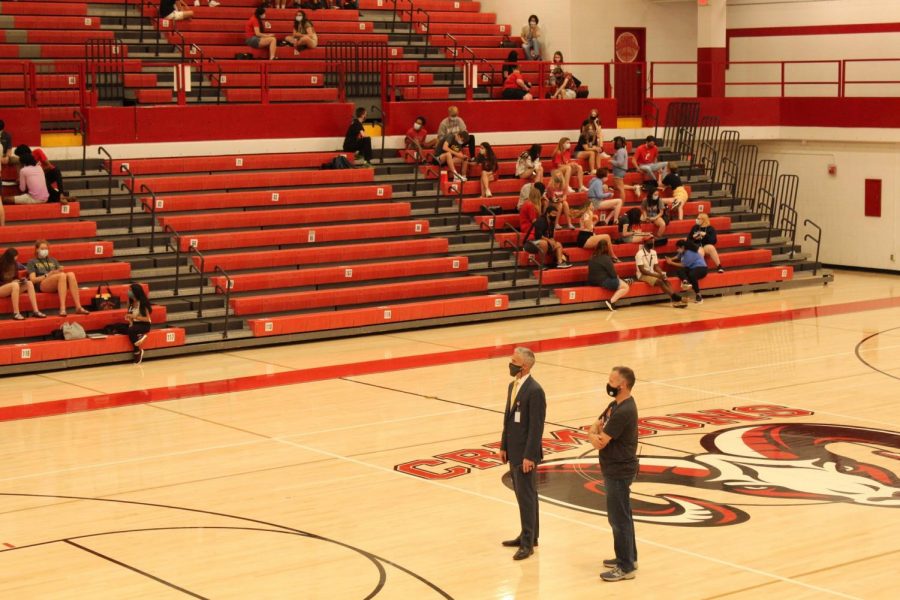 Mr. Kuhn and Mr. K stand watch over the auditorium on the day of the senior walk. Photo by Molly Gregory.