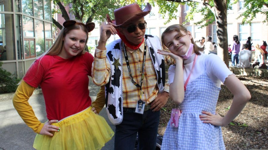Three students pose together as their Disney characters in the courtyard. Photo by Ofelia Mattingly.