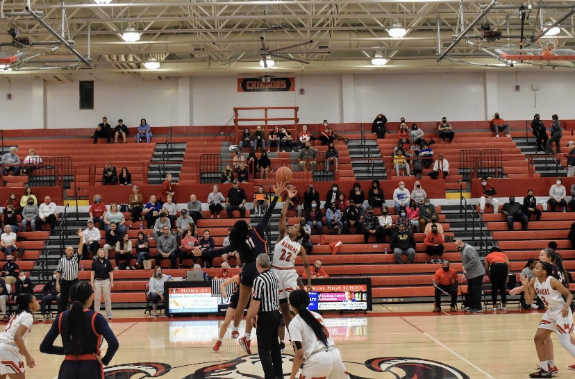 The Tip Off. Daisha White (#22, 12) gets the tip, and Manual goes for the basket. Photo by Emma Tucker.
