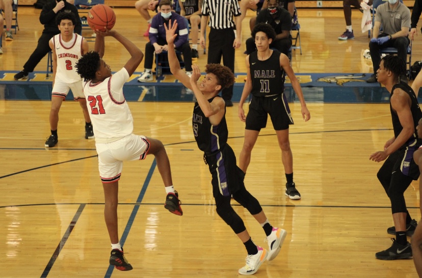 Damone King (#21, 9) shooting over Male during the 2021 Seventh Regional Championship. Photo by Meredith Snyder 