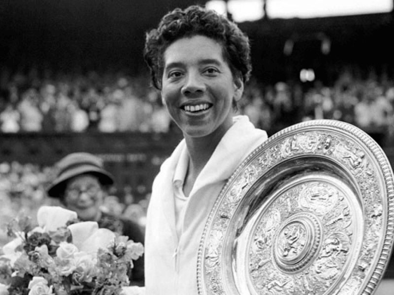 Althea Gibson hoisting her trophy shortly after winning the French Open. 
