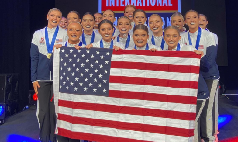The+Dazzlers+hold+up+the+American+flag+after+being+announced+as+the+gold+medal+winners.+Courtesy+of+the+%40manualdazzlers+on+Instagram.