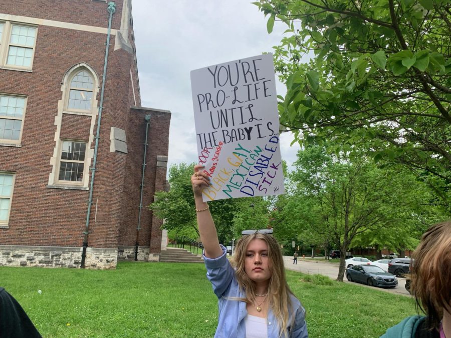 Sophie Shuck holds up a sign at the walkout. Photo by KC Ciresi.