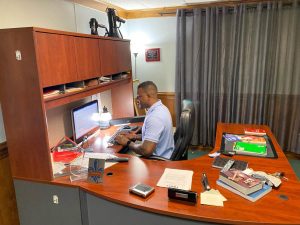 Senior Pastor Tim Findley Jr. works in his office, which sits in the basement of his church. Photo by Brennan Eberwine. 