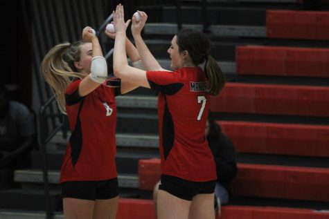 Mary Hoerter and Aubrey Montgomery high five on the court