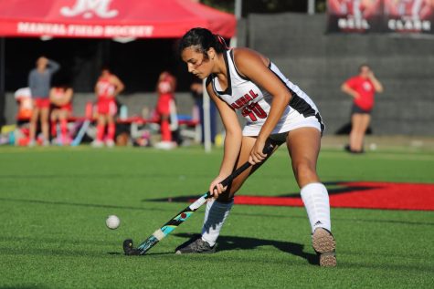 Junior Tori Drepaul recieves a pass from one of her team-mates at a varsity field hockey game