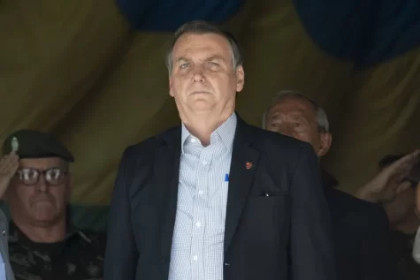 Jair Bolsonaro stands at a military event in Rio. Photo by celsopupo on depositphotos.