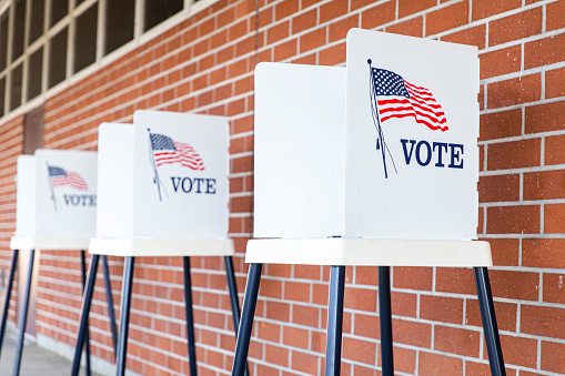 Voting stations like these were used to take ballots in the midterm elections. Photo by Adam Kaz on Unsplash.