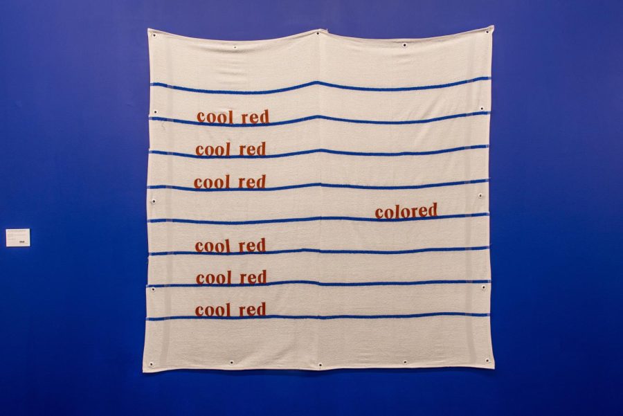 Cool Red is one of three pieces featured in Erasures Edge that rearranges basketball material letters on athletic towels. Photo courtesy of KMAC Museum. 
