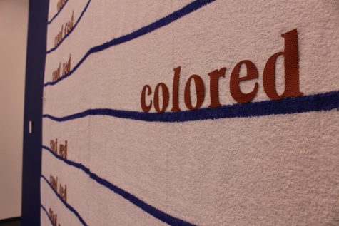 One of three pieces made from athletic towels in the exhibition, Cool Red encourages Black viewers to define themselves with words and erase the hateful words placed onto them. 