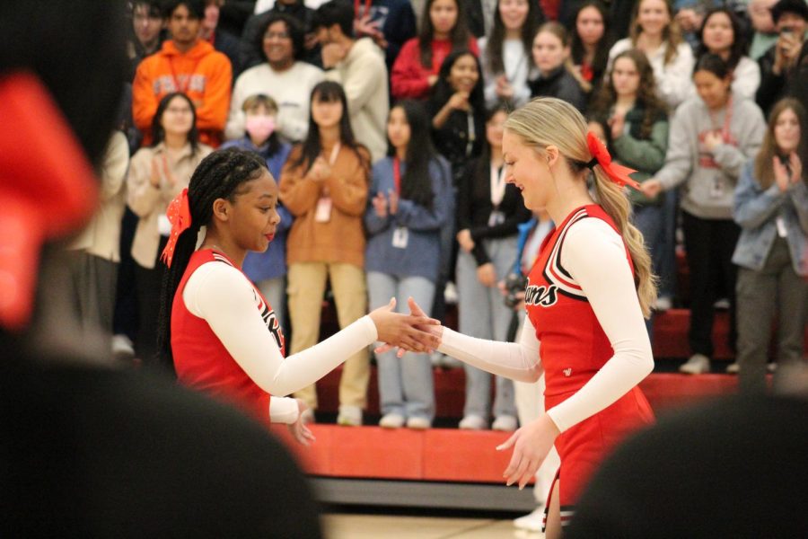Two cheerleaders represent the team at the homecoming pep rally. Photo by Ava Blair