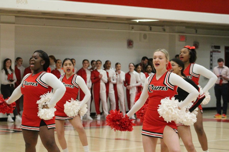 The+cheerleaders+perform+a+routine+in+front+of+the+school+during+a+pep+rally.+Photo+by+Ava+Blair