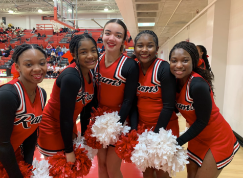 Members of Manual’s cheerleading team pose for a photo. Photo by Katie Dikes