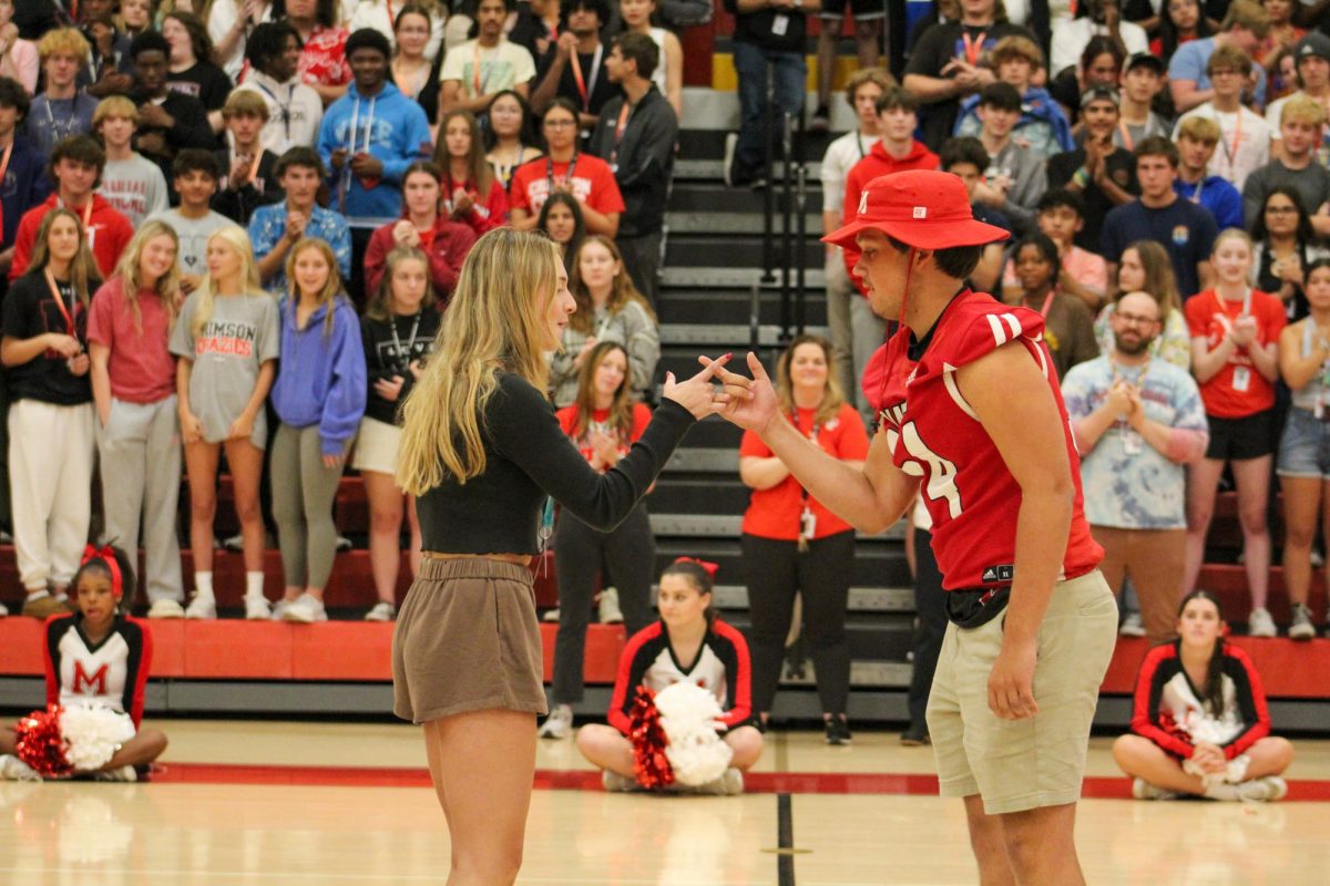 Cameron+Breier+%2812%2C+J%26C%29+and+Spencer+Hague+%2812%2C+HSU%29+high+fiving+after+being+announced+for+homecoming+court.