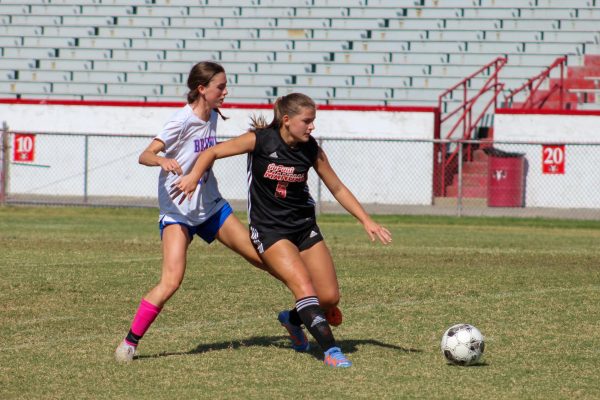 Chloe Groemling (#5, 10) dribbling the ball away from a Brown player.