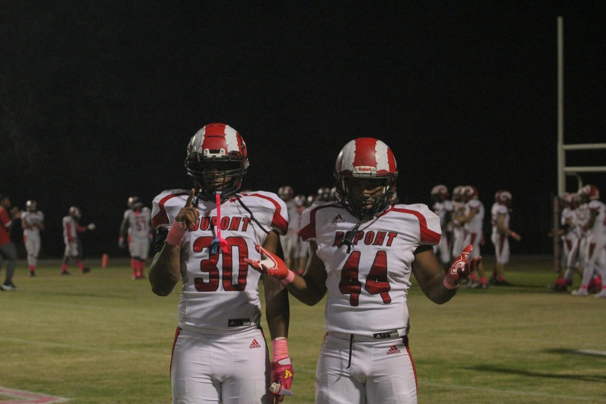 Bryce Ealey (#30, 12) and Jaylen Hayes (#44, 11) posing for a photo on the sidelines.