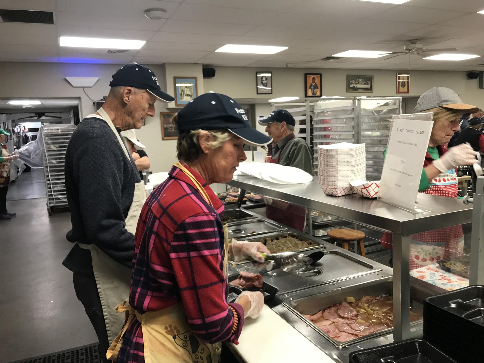Louisville volunteers serve food during the winter months. Photo courtesy of Franciscan Kitchen. 