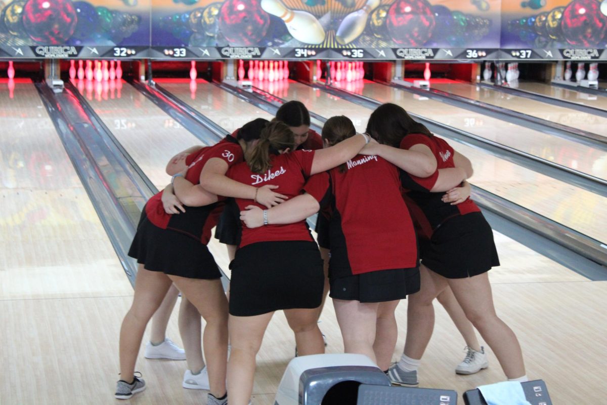 The+girls+bowing+team+huddling+before+the+regional+match.+Photo+by+Lydia+Adams