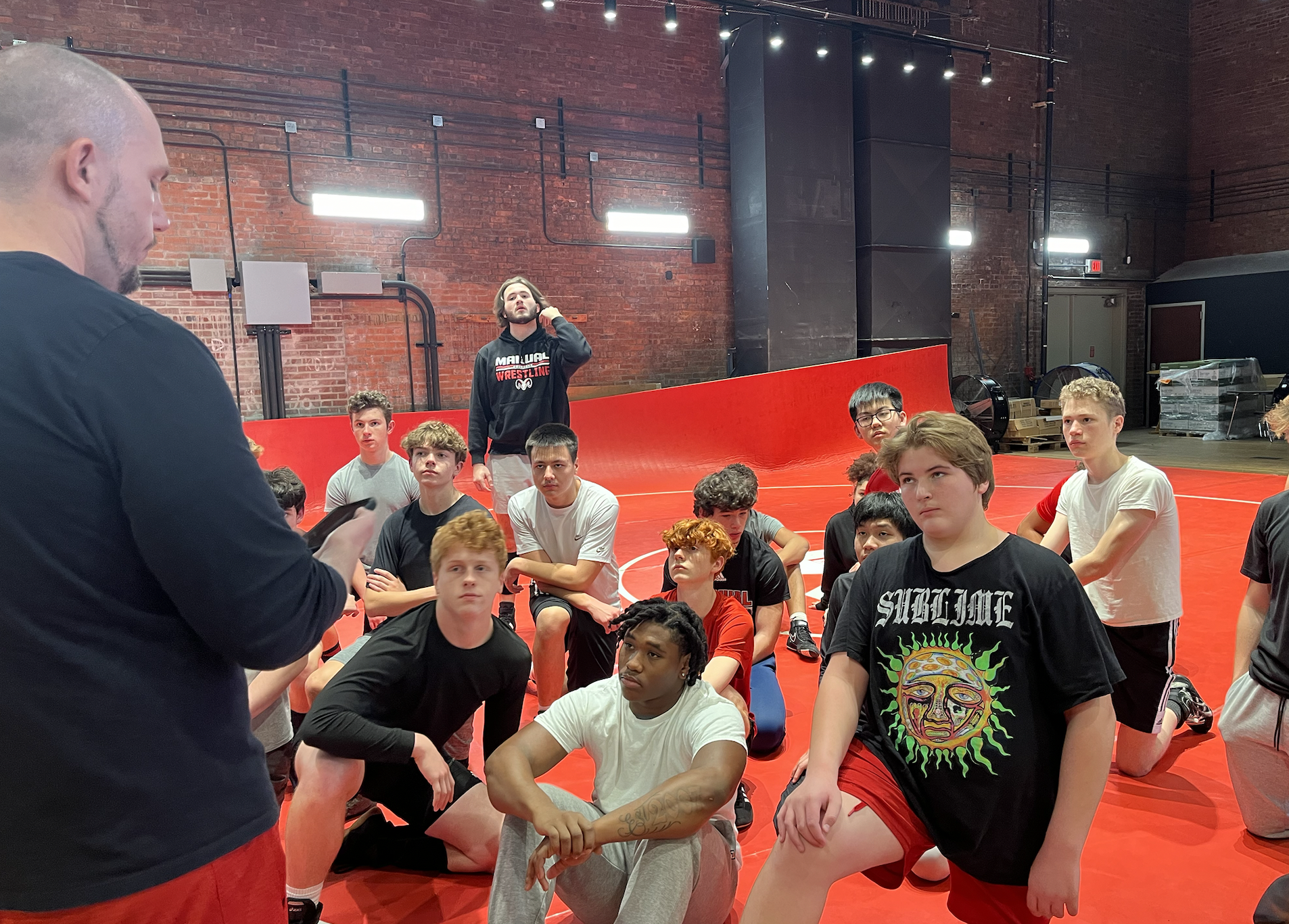The wrestling team listening to Coach Geraci before a practice in December.